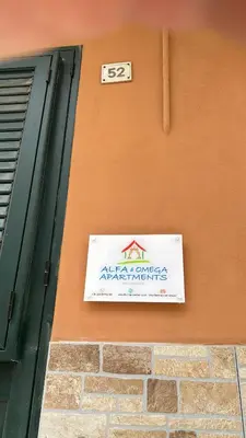 a sign is on the side of a building at Alfa & Omega apartments in Palermo