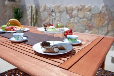 a table with three plates of food on top of it at Corso Alberto in terrazza Palermo in Palermo