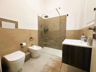a bathroom with a toilet and a sink and a shower at Ai Papiri in Palermo