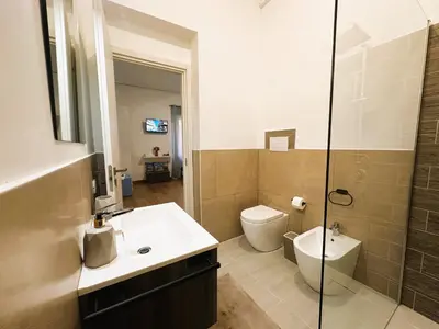 a bathroom with a sink and a toilet and a shower at Ai Papiri in Palermo