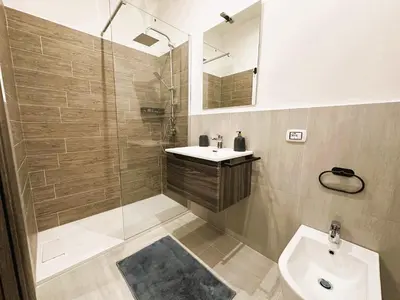 a bathroom with a shower and a sink and a toilet at Ai Papiri in Palermo