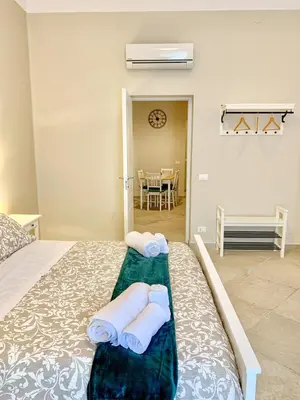 a bedroom with a bed with towels on it at Central Apartment - Le Burnie in Palermo