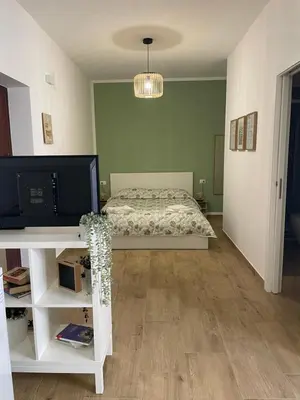 a bedroom with a bed and a table with a tv at Dai Palermitani Rooms & Apartments in Palermo