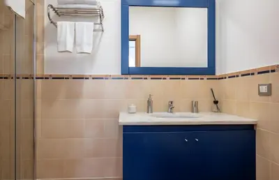 a bathroom with a blue sink and a mirror at Palazzo Monteleone Suite in Palermo