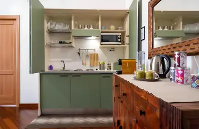 a kitchen with green cabinets and a counter at Palazzo Monteleone Suite in Palermo