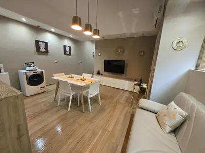 a kitchen and living room with a table and a couch at IL Cavaliere in Palermo