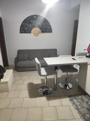 a living room with a table and a couch at Casa Felice in Misilmeri