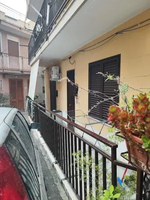 a balcony of a house with a fence and a car at Casa Felice in Misilmeri