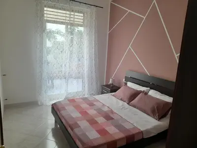 a bedroom with a bed and a large window at casa vacanza tobruk in Castellammare del Golfo