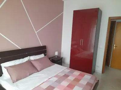 a bedroom with a bed and a red closet at casa vacanza tobruk in Castellammare del Golfo