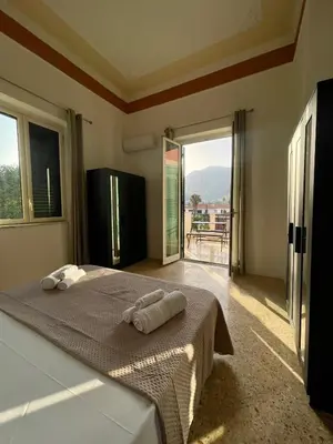 a bedroom with a bed with two towels on it at Catilì Apartment in Palermo