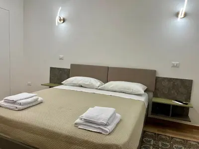 a bedroom with a bed with towels on it at Al Duomo Suites in Monreale