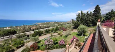 a view from the balcony of a house with flowers at Costa Azzurra Cefalù Residence in Cefalù