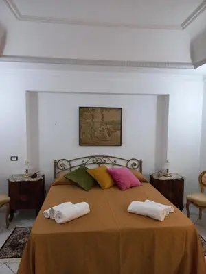 a bedroom with a bed with two towels on it at Al Palazzo Del Principe al Massimo in Palermo