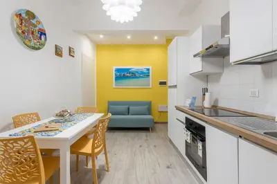 a kitchen and dining room with a table and chairs at Orleans Apartment in Palermo