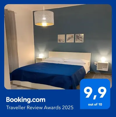 a bedroom with a bed with a blue blanket at Orleans Apartment in Palermo