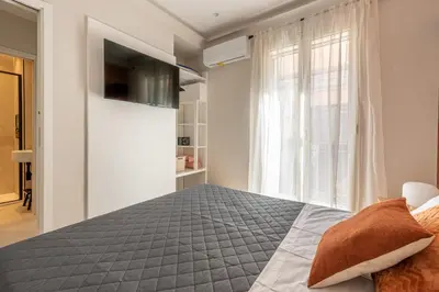 a bedroom with a large bed and a window at Le perle del capo in Palermo