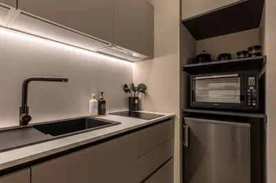 a kitchen with a sink and a microwave at Le perle del capo in Palermo