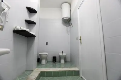 a white bathroom with two toilets and a shower at Medea Suite Panoramic in Palermo