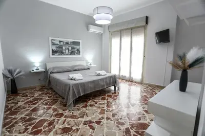 a bedroom with a bed and a large window at Medea Suite Panoramic in Palermo