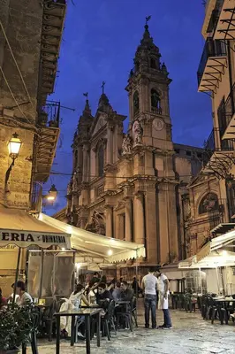 a large building with a clock tower and people standing outside at Agghiorna&skura 2,0 in Palermo