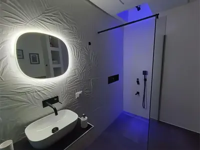 a bathroom with a sink and a mirror and a shower at Agghiorna&skura 2,0 in Palermo