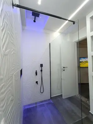 a bathroom with a shower with a glass door at Agghiorna&skura 2,0 in Palermo