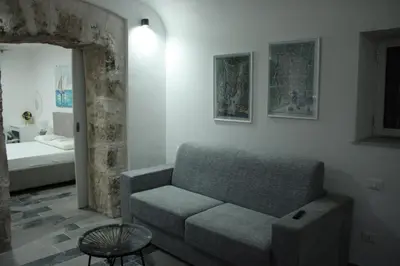 a living room with a couch and a bed at Casa varco Santa Lucia in Palermo