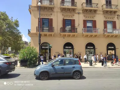 a small blue car parked in front of a building at Casa varco Santa Lucia in Palermo