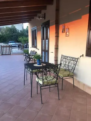 a table and chairs sitting on a patio at Macari House in Macari