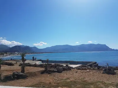 a large body of water with mountains in the background at VILLA BUTTERFLY 2 a FEW STEPS FROM THE SEA in Capaci