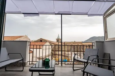 a balcony with chairs and a view of a church at Molinari Palermo in Palermo