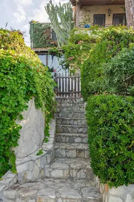 a stone path in front of a house at Alle due Torri, villa sulla roccia a picco sul mare in Altavilla Milicia