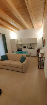 a living room with a couch and a kitchen at Crihouse in Palermo