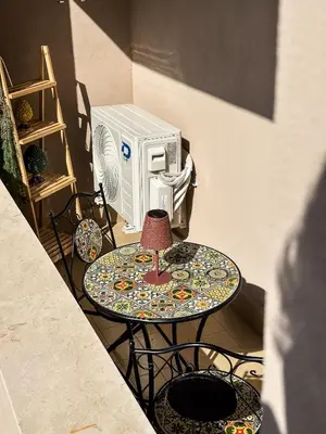 a table with a lamp next to a microwave at Appartamento completo con parcheggio privato - Villa Ciaculli in Villabate