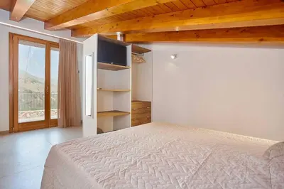 a bedroom with a bed and a large window at Villa Ninfa in Castellammare del Golfo