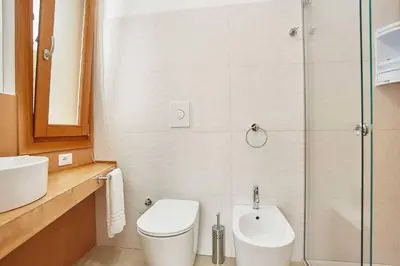 a bathroom with a toilet and a sink and a shower at Villa Ninfa in Castellammare del Golfo