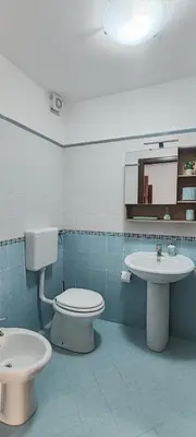 a bathroom with a toilet and a sink at Casa Vacanze In Piazza in Terrasini