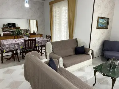 a living room with a couch and a dining room at Casa Vacanze Villa Lena in Santa Flavia
