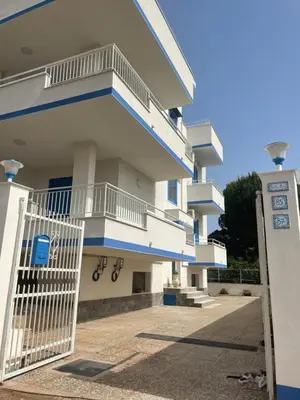 a white building with a gate in front of it at Casa Vacanze Villa Lena in Santa Flavia