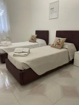 two twin beds in a room with at Casa Vacanze Villa Lena in Santa Flavia
