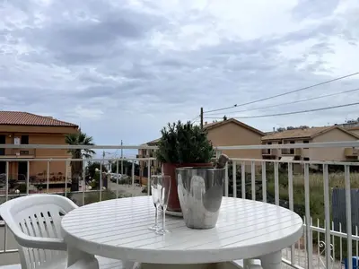 a white table with a potted plant on a balcony at Casa Vacanze Villa Lena in Santa Flavia