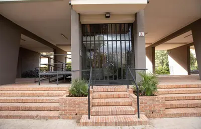 a building with stairs leading to a glass door at Nothotel delle Rose in Palermo