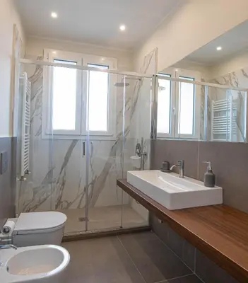 a bathroom with a sink and a shower and a toilet at Nothotel delle Rose in Palermo
