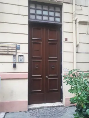 a brown door on the side of a building at Casa Dam'Arte in Palermo
