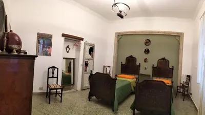 a living room with two chairs and a couch at Casa Dam'Arte in Palermo