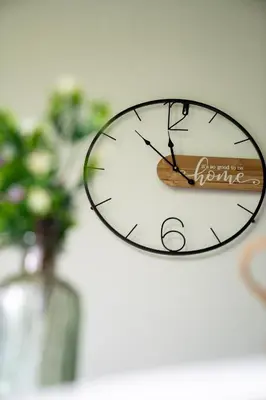 a clock hanging on a wall with a vase at Intero Appartamento con Solarium - Villa Ciaculli in Palermo
