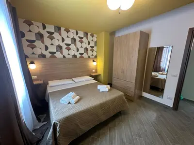 a bedroom with a bed with two towels on it at Intero Appartamento con Solarium - Villa Ciaculli in Palermo