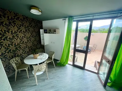 a room with a table and chairs and a patio at Intero Appartamento con Solarium - Villa Ciaculli in Palermo