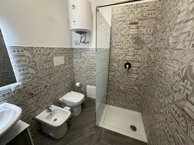a bathroom with a shower and a toilet and a sink at Intero Appartamento con Solarium - Villa Ciaculli in Palermo